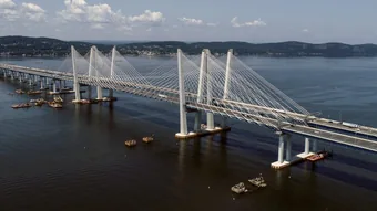 The cable-stayed Gov. Mario M. Cuomo Bridge
                        (the rebuilt Tappan Zee) crossing the wide
                        Hudson River, seen from above.
