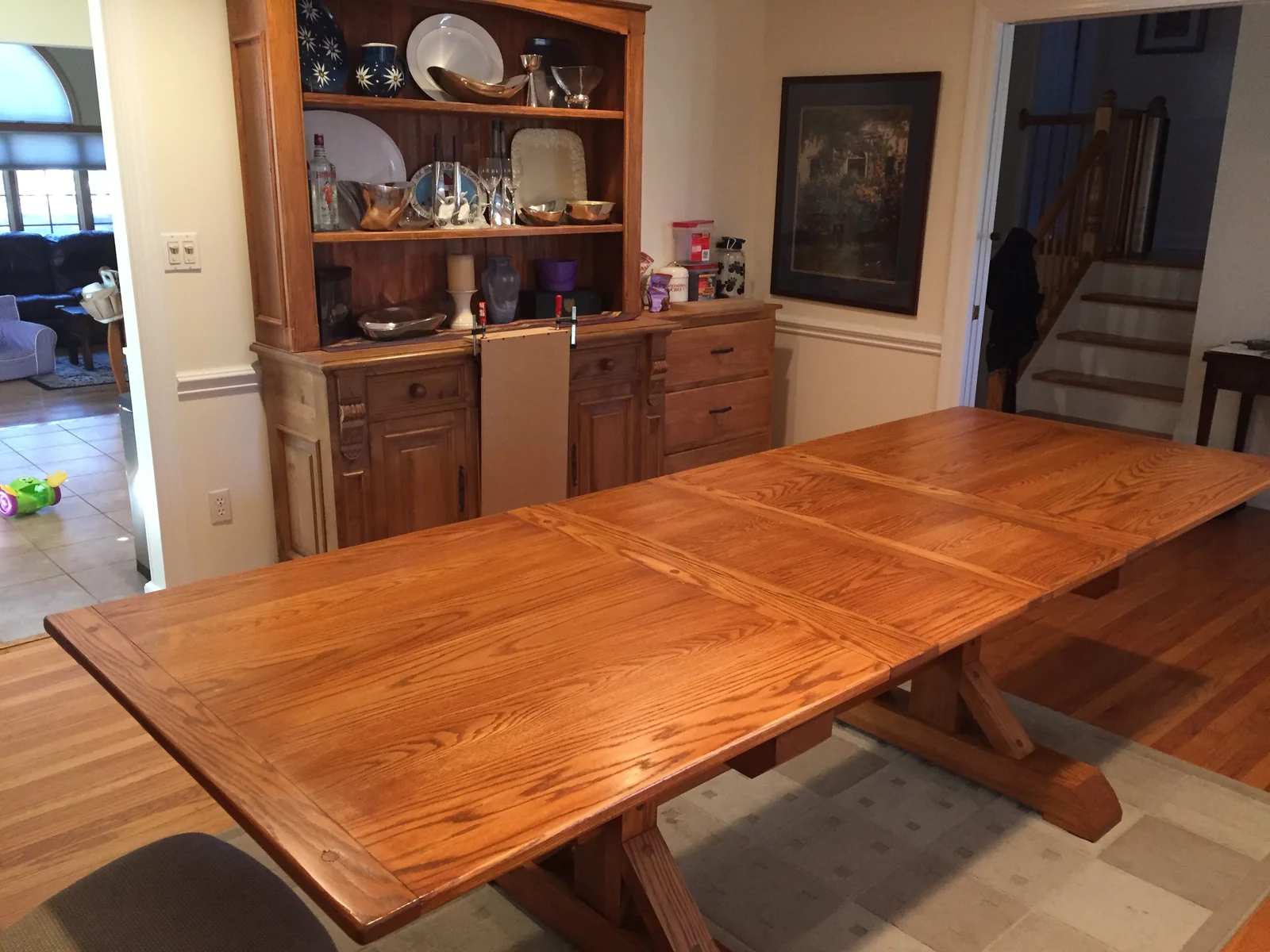 The finished trestle dining table, stained and
                    sealed, in place in the dining room.