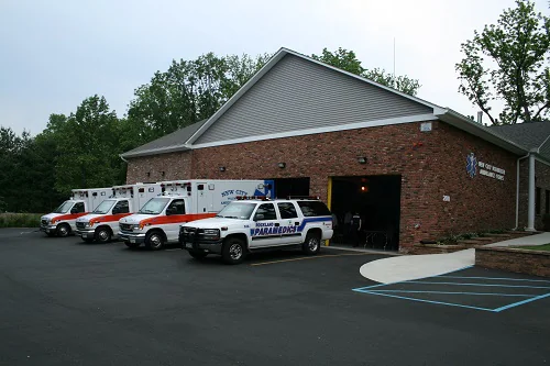 The New City Volunteer Ambulance Corps building
                      with three ambulances and a paramedic vehicle
                      parked out front.